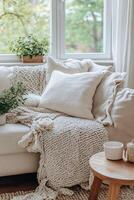 Cozy living room corner adorned with soft textiles and greenery photo