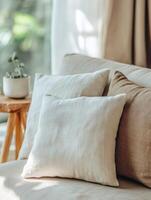 Soft pillows on a cozy sofa in a sunlit living room photo