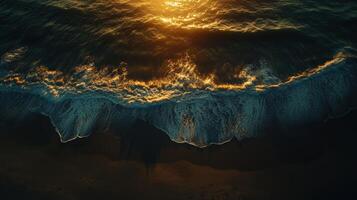 Waves gently rolling onto the shore at sunset along a tranquil beach photo