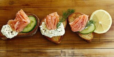 Delicious smoked salmon bruschetta with cream cheese and cucumber slices photo