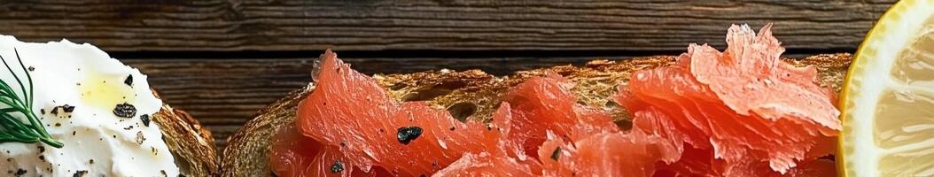 Fresh salmon tartine with cream cheese and lemon on rustic wooden table photo
