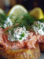 Delicious smoked salmon on toasted bread with fresh herbs and lemon slices photo