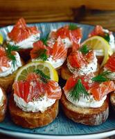 Smoked salmon canapes with cream cheese and lemon at a gathering photo