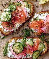 Gourmet open-faced sandwiches with smoked salmon and fresh vegetables photo