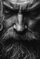 Intense close-up of a bearded man with striking facial features and expression photo