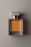Elegant perfume bottle placed on a smooth surface showcasing its amber liquid photo