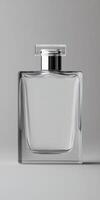 Elegant clear glass perfume bottle on gray background photo