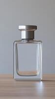 Elegant glass fragrance bottle with silver cap on wooden surface photo