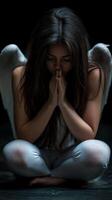 Reflective moment of a woman with angel wings in a serene setting photo