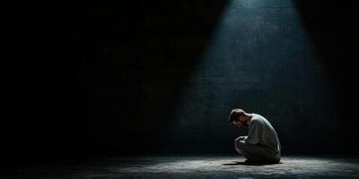 Man in a dark room experiencing solitude and reflection during a quiet moment photo