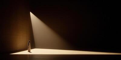 Light illuminates a figure standing in a darkened space photo