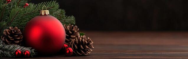 Decorated red ornament surrounded by pine branches and cones for holidays photo