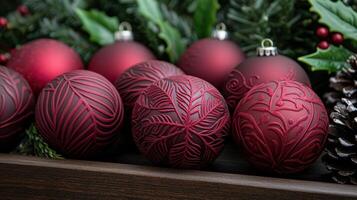 Festive red holiday ornaments with intricate designs on a wooden tray photo