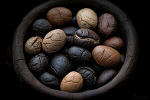 Various types of coffee beans in a rustic wooden bowl on a dark background photo
