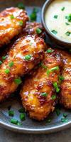 Crispy fried chicken strips served with savory dipping sauce photo