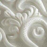 Intricate white textile featuring elegant lace-like patterns and designs photo