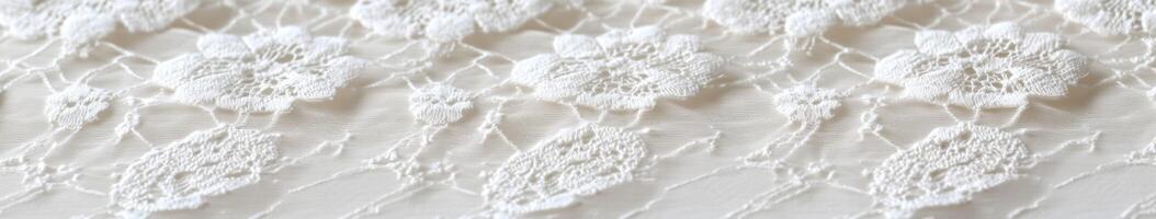 Intricate white lace fabric with floral patterns on a soft surface photo