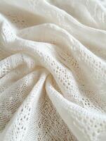 Delicate white lace fabric showcasing intricate patterns and textures photo