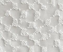 Textured white fabric with intricate patterns in natural light photo