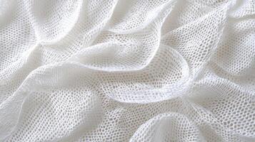 Soft white fabric draping gracefully across a flat surface in natural light photo