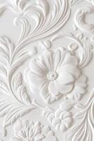Elegant white floral relief detailing in intricate design on wall surface photo