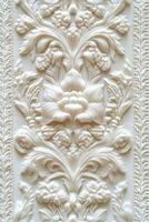 Intricate white relief artwork showcasing floral patterns and textures photo