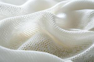 Textured white fabric creating soft folds with delicate patterns photo