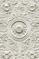 Intricate white floral design on textured wall paneling in a modern room photo