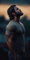 Muscular man gazes thoughtfully at the evening sky in a serene setting photo