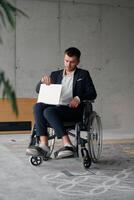 A director in a suit sitting in a wheelchair, using a ball in a modern office, embodying adaptability, focus, and leadership while navigating challenges in the workplace photo