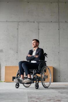 A director in a wheelchair sitting alone in an empty office, deeply reflecting on business strategies and decisions, contemplating the path forward with focused determination. photo