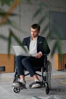 A director in a suit sitting in a wheelchair, using a ball in a modern office, embodying adaptability, focus, and leadership while navigating challenges in the workplace photo