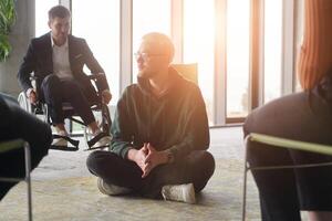 Corporate business team meeting with a manager or coach. Group of happy diverse, multiracial people sitting in a circle photo