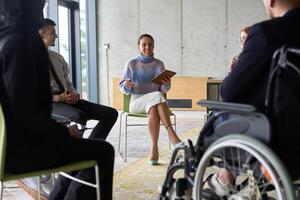 Corporate business team meeting with a manager or coach. Group of happy diverse, multiracial people sitting in a circle photo