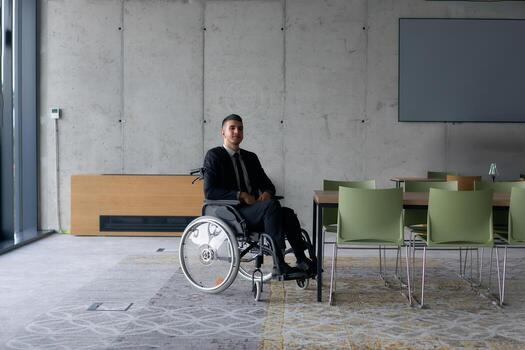 A director in a wheelchair sitting alone in an empty office, deeply reflecting on business strategies and decisions, contemplating the path forward with focused determination. photo