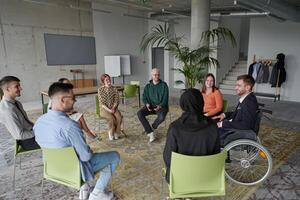 Corporate business team meeting with a manager or coach. Group of happy diverse, multiracial people sitting in a circle photo