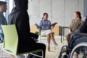 Corporate business team meeting with a manager or coach. Group of happy diverse, multiracial people sitting in a circle photo