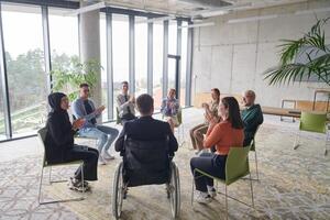 Corporate business team meeting with a manager or coach. Group of happy diverse, multiracial people sitting in a circle photo