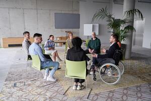 Corporate business team meeting with a manager or coach. Group of happy diverse, multiracial people sitting in a circle photo