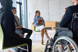 Corporate business team meeting with a manager or coach. Group of happy diverse, multiracial people sitting in a circle photo