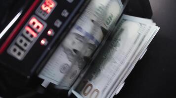 Macro view counter counting machine counting 100 American dollar bills. Concept of money. Business finance. Cash money video