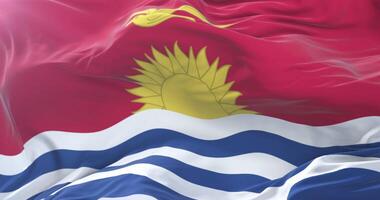 Kiribati flag waving at wind in slow in blue sky, loop video