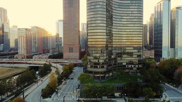 Modern Chicago skyscrapers at sunset. Aerial view of modern skyscrapers in downtown Chicago with sunset reflections on glass buildings and urban streets below. video