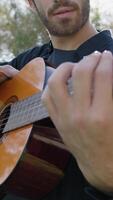 Playing Guitar And Tapping With Hand On Sound Box In A Park video