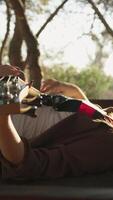 Girl Plays Bass Musical Instrument Lying On Table In Mountains video