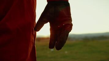 Hand of an Astronaut with Glove Shakes a Fist in Front of a Wasteland at Sunset video