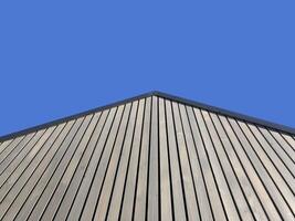 striped plank wall transitioning into gable, low angle view photo