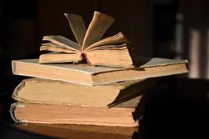 Pile of old books. A stack of several yellow books on the table. Education concept. photo