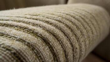 A closeup view of hemp fabric upholstery highlights the intricate woven texture and natural fibers, reflecting its eco-friendly and sustainable nature. photo