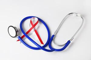 Red and white ribbon with stethoscope medical concept photo